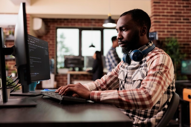 freelance coder typing javascript code on computer to develop online cloud computing information. software developer writing html script and data algorithm, working in it programming office