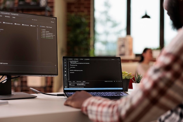 software developer programming firewall security on multiple monitors, learning new user interface. developing application cloud server with binary code and html script on terminal window.