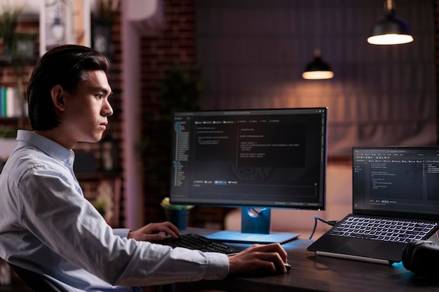 asian engineer developing app software on computer, working with binary code program to create firewall security server. programming application code with cloud computing on high tech interface.