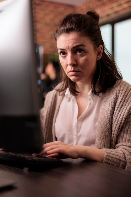 company coder writing javascript code on computer, sitting at desk parsing algorithm in it programming agency. software developer working on app developing program. network technology concept
