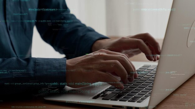 computer programmer uses capable laptop computer to develop programming code