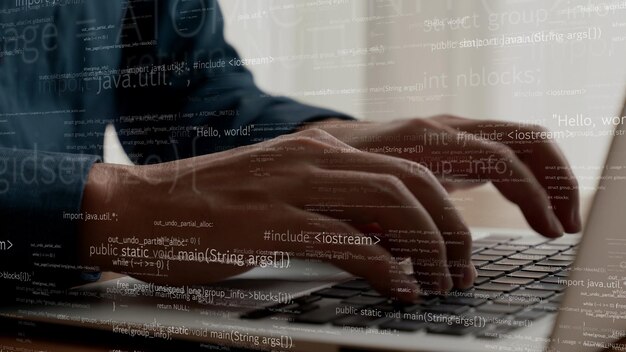 computer programmer uses capable laptop computer to develop programming code