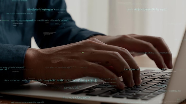 computer programmer uses capable laptop computer to develop programming code