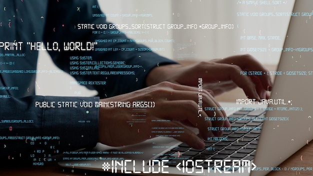computer programmer uses capable laptop computer to develop programming code