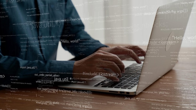 computer programmer uses capable laptop computer to develop programming code