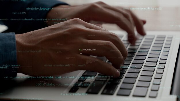 computer programmer uses capable laptop computer to develop programming code