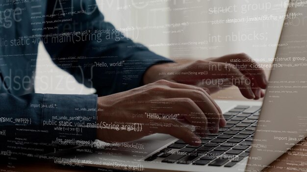 computer programmer uses capable laptop computer to develop programming code