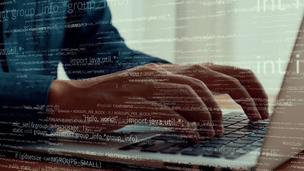 computer programmer uses capable laptop computer to develop programming code