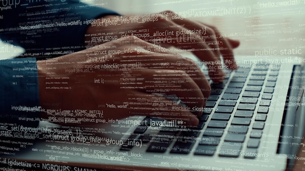 computer programmer uses capable laptop computer to develop programming code