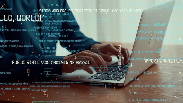 computer programmer uses capable laptop computer to develop programming code