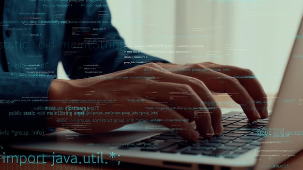 computer programmer uses capable laptop computer to develop programming code