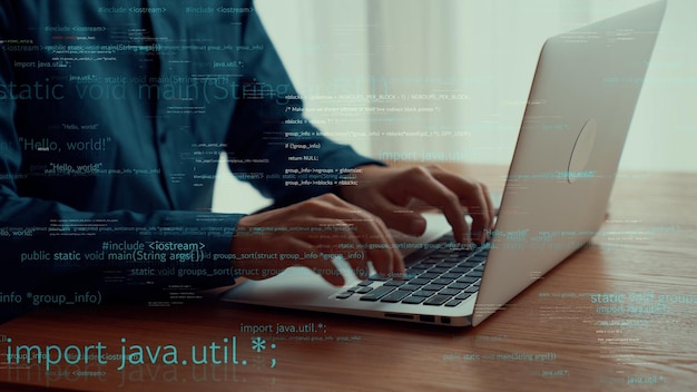 computer programmer uses capable laptop computer to develop programming code