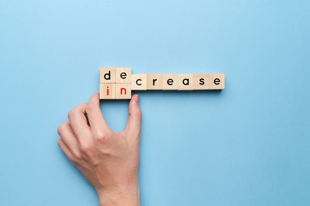 concept of decrease and increase on wooden cubes