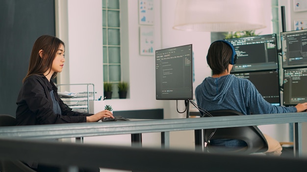 database programer writing source code with coding language in it development room. app developer working on database programming with html script, computing big data. handheld shot.