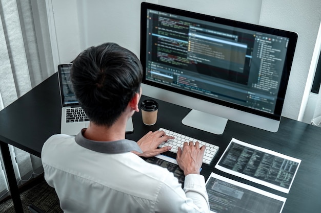 developer programmer working on coding program software computer in office