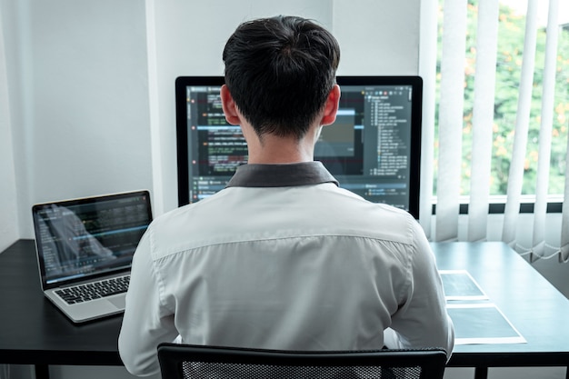 developer programmer working on coding program software computer in office