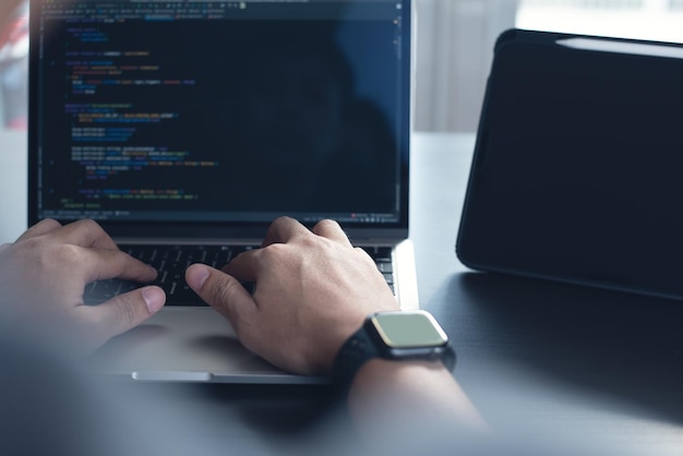 developing programmer software developer coding computer code on laptop computer digital software development website and mobile app design and coding technologies