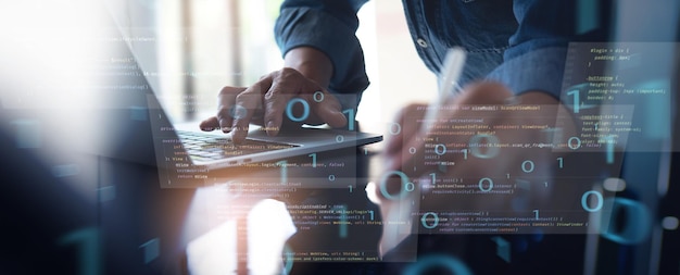 digital software technology mobile app development concept computer programmer software developer coding on laptop computer with javascript and binary code
