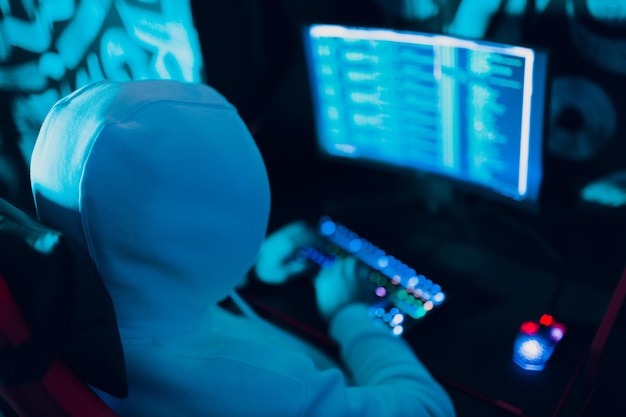 hacker using computer malware software and hacking binary code digital interface