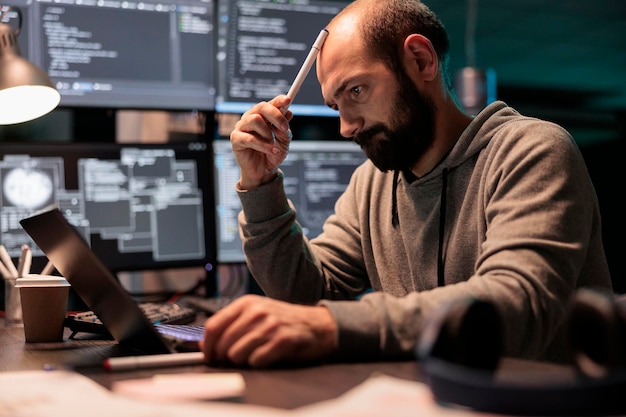 pensive coder brainstorming ideas to find source code and develop html script on terminal window. thinking about solution to create cloud computing server interface, coding program.