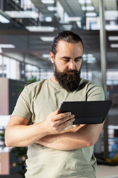 programmer doing software debugging using tablet checking errors in lines of code man working in