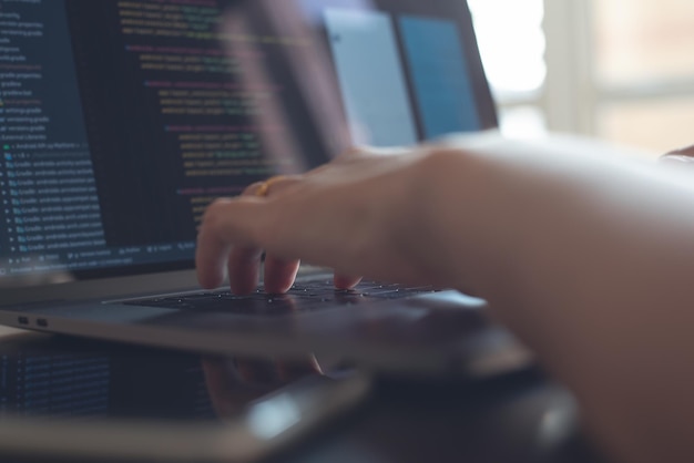 programmer software developer coding html program javascript on laptop computer