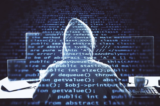 programmer using computer with programming code