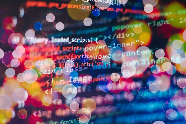 programmer working in a software develop company office. digital binary data on computer screen. computer script typing work. programming code abstract screen of software developer.