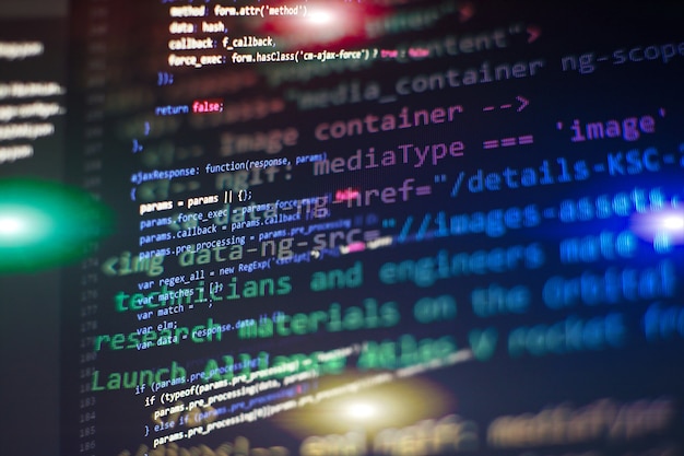 programmer working in a software develop company office. digital binary data on computer screen. computer script typing work. programming code abstract screen of software developer.