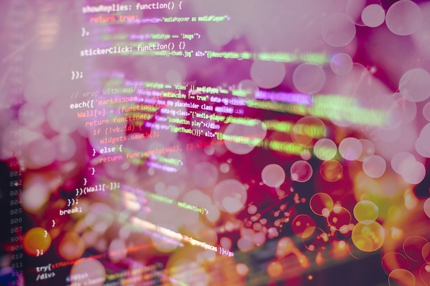 programmer working in a software develop company office. digital binary data on computer screen. computer script typing work. programming code abstract screen of software developer.