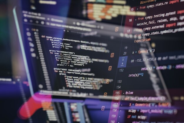 programming code analysis with software testing debugging interface and developer tools on multiple computer displays
