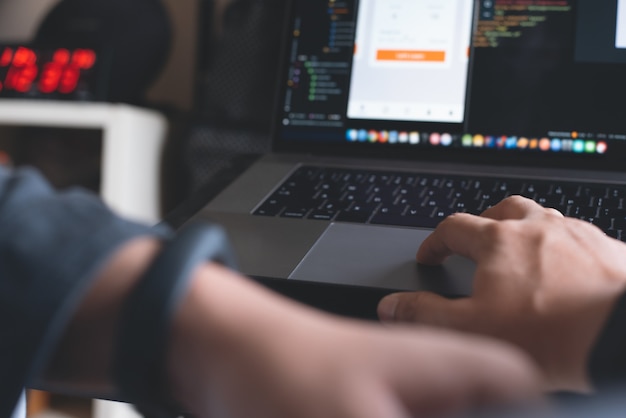 software developer coding javascript on laptop computer