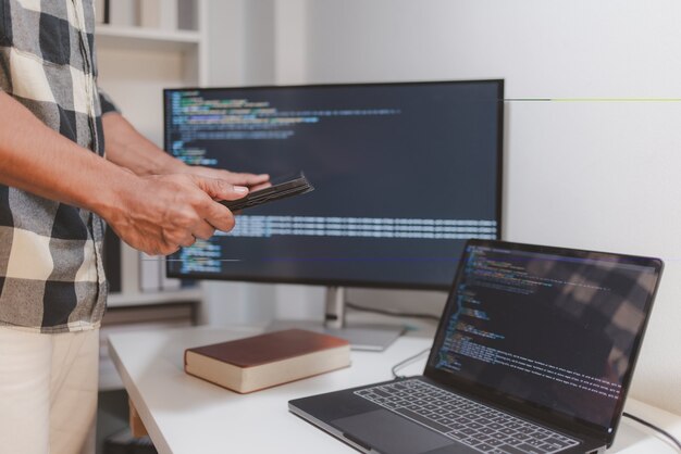 software developer coding on laptop and tablet in a modern workspace closeup of programming workflow software engineering debugging source code and multidevice application development