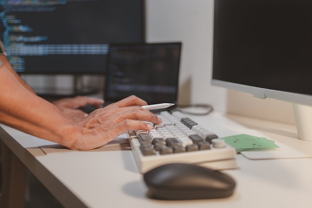 software developer coding on laptop and tablet in a modern workspace closeup of programming workflow software engineering debugging source code and multidevice application development