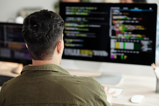 software developer looking at programming code