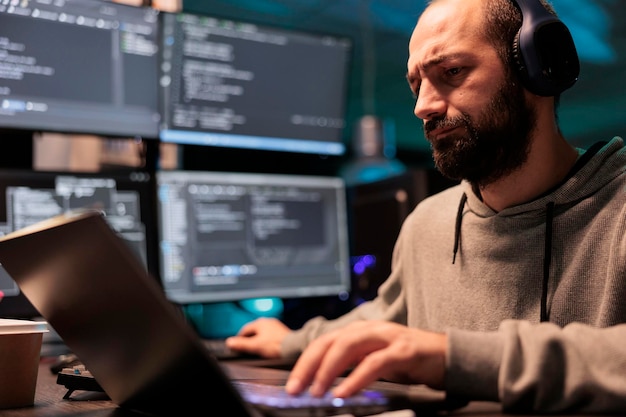 software developer programming user interface on computer and compiling source code with html script and algorithms. coding cloud computing online program on multiple screens at night.