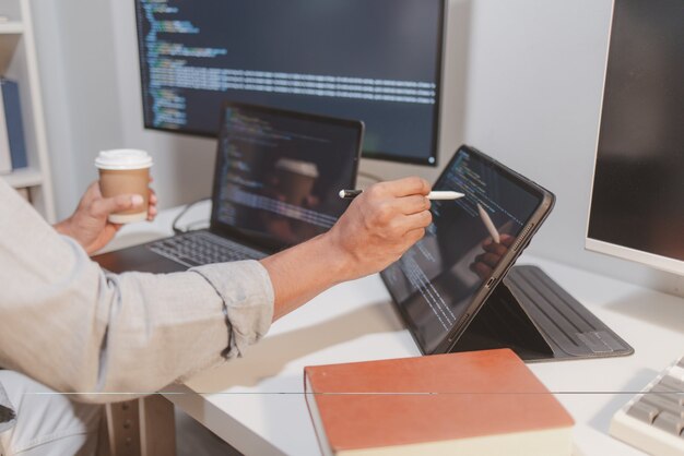 software developer reviewing source code while taking a coffee break in a modern workspace programming workflow with debugging code analysis and focused software development