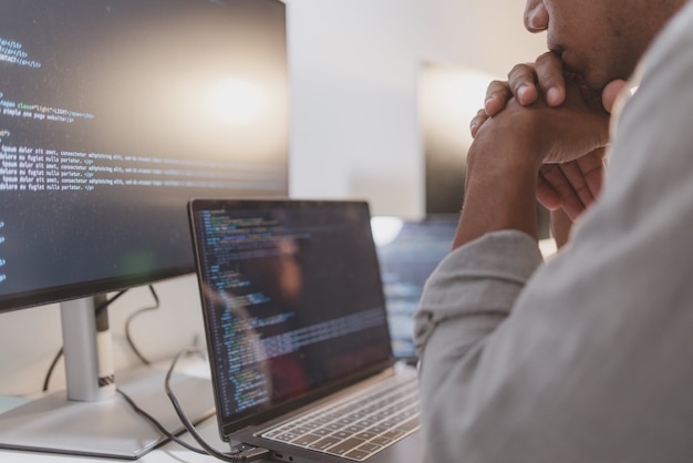 software developer reviewing source code while taking a coffee break in a modern workspace programming workflow with debugging code analysis and focused software development