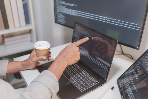 software developer reviewing source code while taking a coffee break in a modern workspace programming workflow with debugging code analysis and focused software development