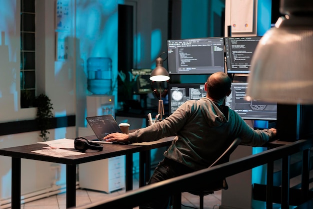 software developer typing programming code on computer with multiple monitors, working with html script. developing algorithms for artificial intelligence on terminal window, cloud computing.