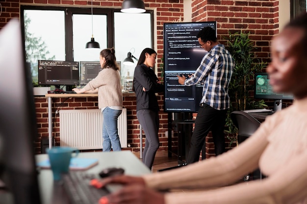 tech enginners using binary code to script security system, programming firewall encryption. diverse team working with program data server to develop network on coding software. programmer concept