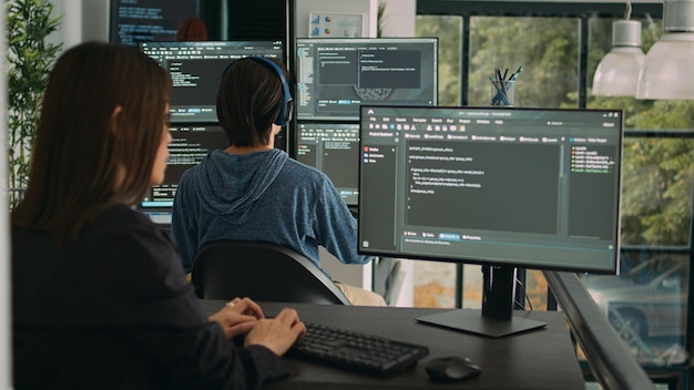 woman programer typing source code on computer keyboard to develop new app server, cloud computing. software engineer coding program algorithm on terminal window with html script.