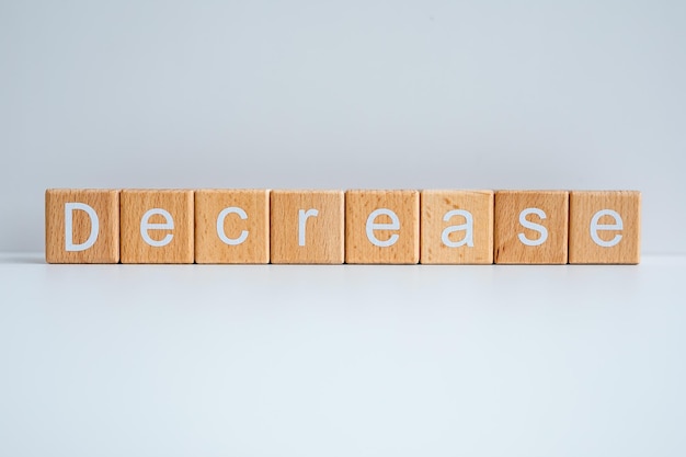wooden blocks form the text decrease against a white background